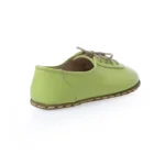 women barefoot green shoes